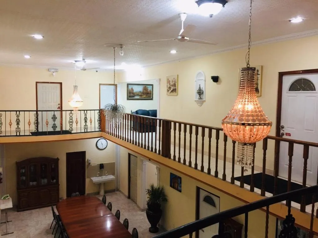 Banquet hall atrium with crystal chandelier, balcony and long dining table