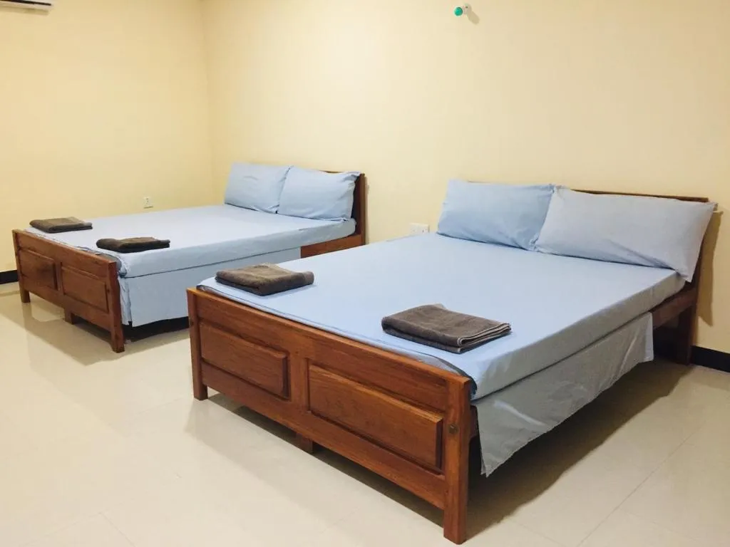 Twin room with two double beds and fresh towels
